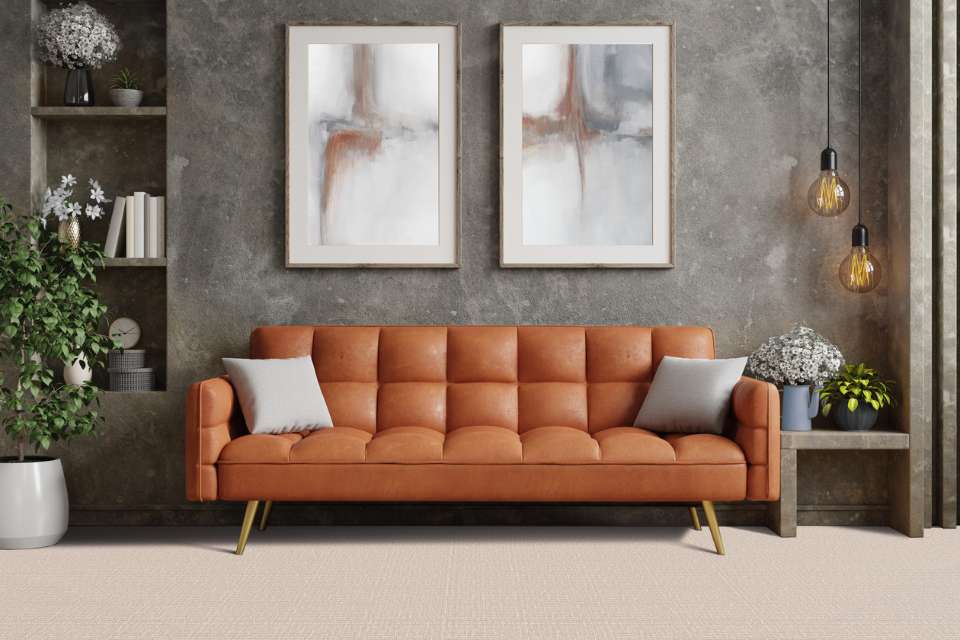 beige patterned area rug in retro style living room with leather couch and gray washed accent wall